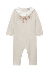 Combinaison en tricot beige clair à manches longues, col blanc à volants et broderie florale avec un nœud. Poignets côtelés aux chevilles.