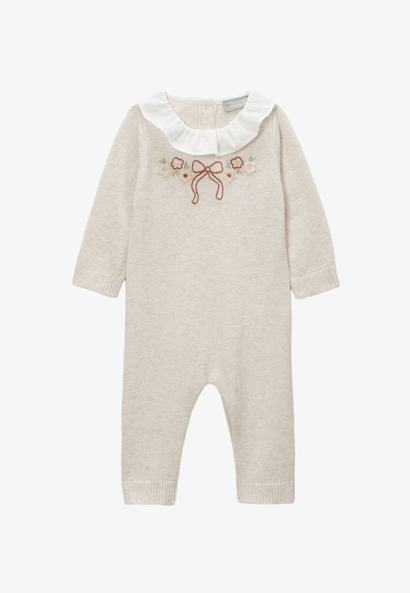 Combinaison en tricot beige clair à manches longues, col blanc à volants et broderie florale avec un nœud. Poignets côtelés aux chevilles.