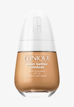 Clinique Even Better Clinical serum foundation in a transparent glass bottle with a rounded base, white cap, and tan liquid. SPF 20.