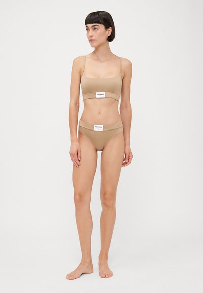 Beige crop top and high-waisted bikini set made of smooth, stretchy fabric with branded elastic bands, minimal seams, and a fitted design.