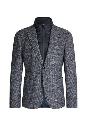 Blazer van een wolmix in marineblauw en grijs hondentandpatroon, met een doorgestikte bodywarmer met rits eronder, klepse revers en twee zakken aan de voorkant.
