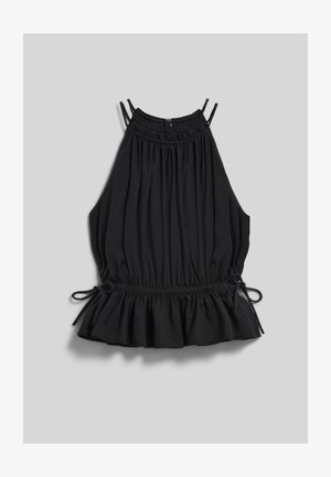 Haut sans manches noir à col halter avec tissu froncé, taille élastique avec liens latéraux et ourlet à volants sur fond gris clair.