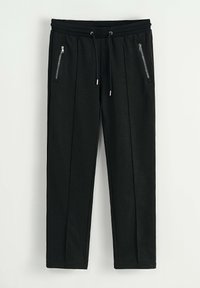 Pantalons de jogging noirs avec une taille élastique, un cordon de serrage et deux poches latérales zippées. Le matériau semble texturé. Design à jambe droite.