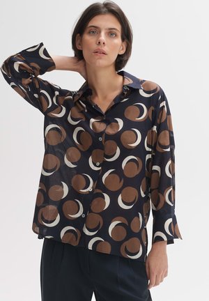 Navy button-up shirt featuring a circular pattern in brown and cream. Made from a lightweight fabric with long sleeves and a relaxed fit.