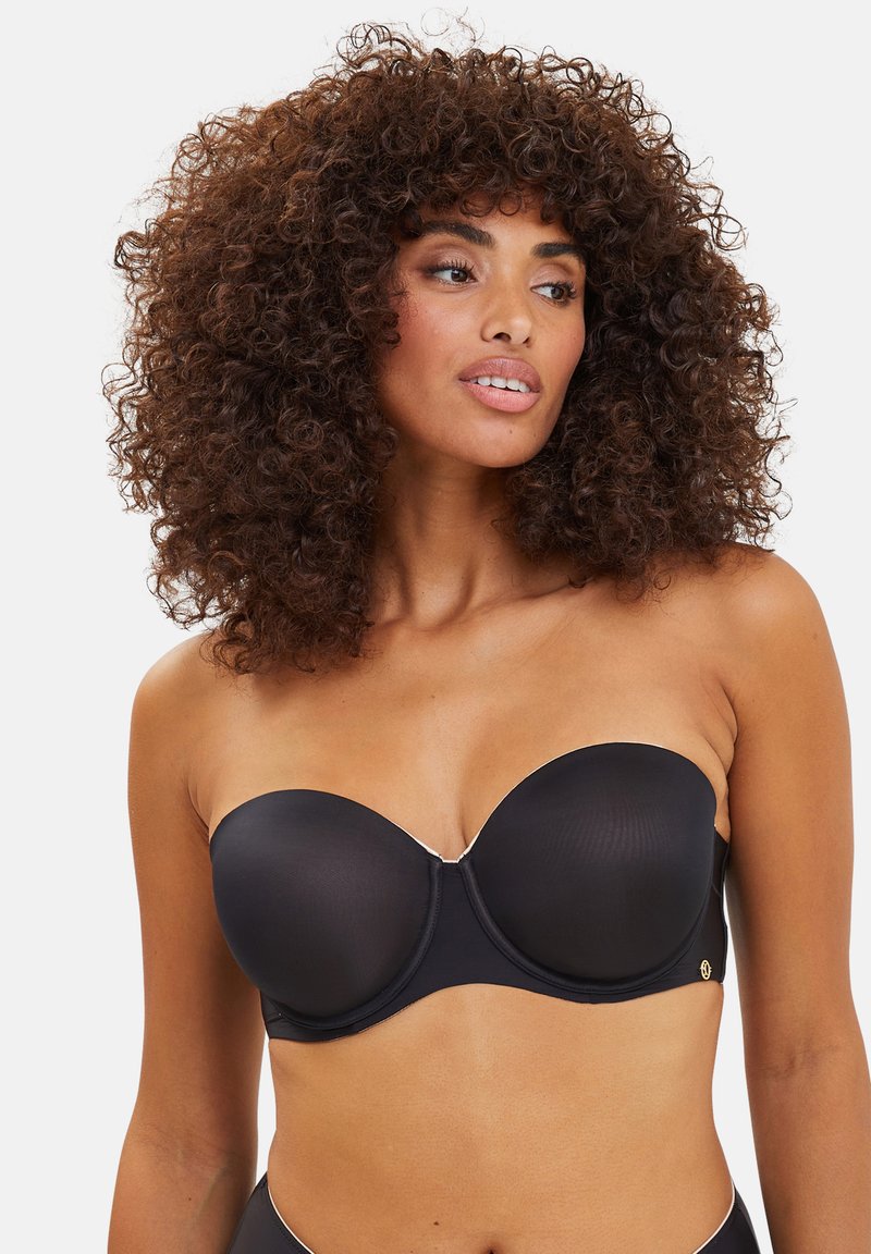 Reggiseno nero senza spalline con coppe sagomate, texture opaca liscia e sottili dettagli in metallo argentato lungo il bordo superiore.