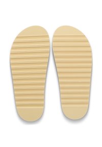 Εσωτερικά πέλματα παπουτσιών από καουτσούκ σε ανοιχτό καφέ χρώμα με υφή που διαθέτει οριζόντιες αυλακώσεις για καλύτερη πρόσφυση. Στρογγυλεμένες άκρες και λεία κάτω πλευρά.