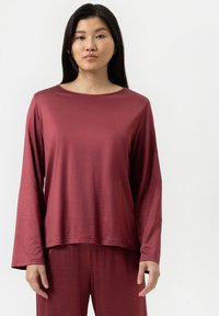 Bordeaux lange mouw top gemaakt van een soepele, lichtgewicht stof, met een bootnek en een ontspannen pasvorm, gecombineerd met bijpassende broek.