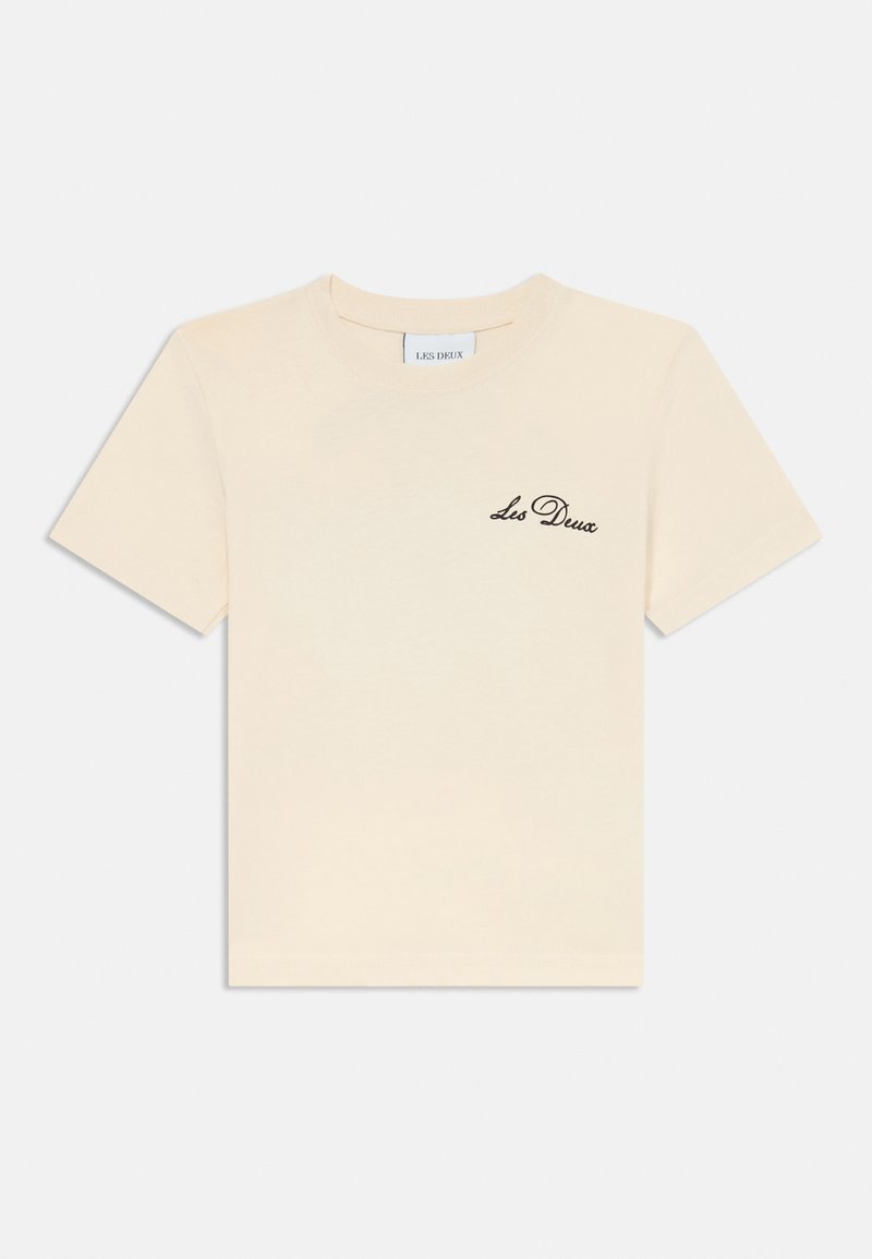 Kurzärmliges cremefarbenes T-Shirt aus Baumwolle mit einem schwarzen gestickten "Les Deux"-Logo auf der linken Brustseite. Sanfte Textur, reguläre Passform.