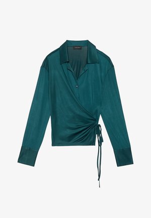 Rohke teal toode pikkade varrukatega, nööbitud kaelustega ja kokku kogutud külje detailiga. Sile kangas, millel on minimaalne sära ja sirged mansetid.