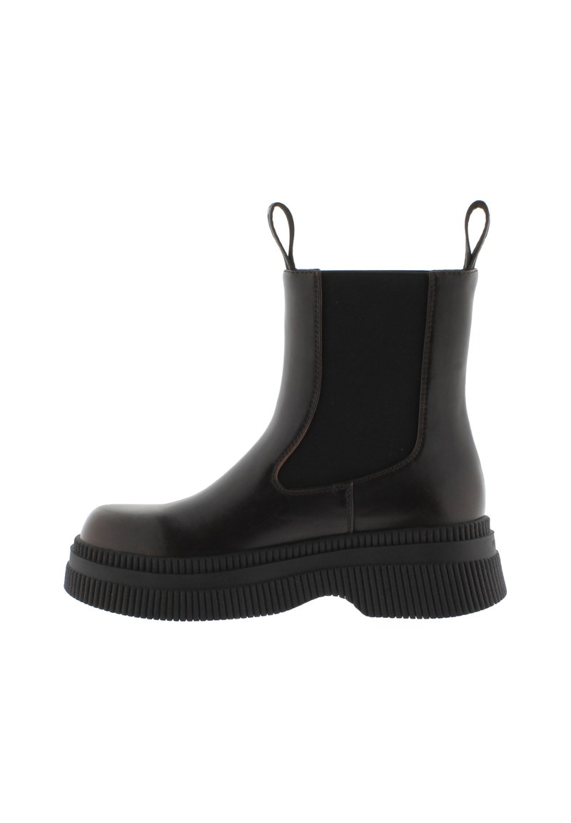 Botas Chelsea de goma negra con paneles laterales elásticos, suela texturizada y gruesa, y asas en la parte trasera para facilitar su uso.
