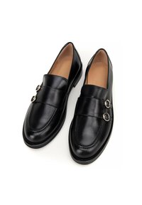 Zwarte leren loafers met een gladde afwerking, ronde neus, dubbele decoratieve gespen en een lage, platte zool. Interieur gevoerd in beige.