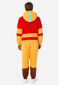 Red and yellow onesie with a soft texture, features a blue arrow on the hood, and brown accents at the ankles and wrists.