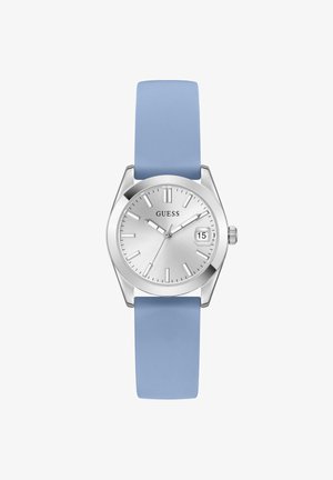 Montre-bracelet Guess argentée avec bracelet en silicone bleu clair, cadran minimaliste, affichage de la date à 3 heures, et index ainsi que aiguilles argentés.