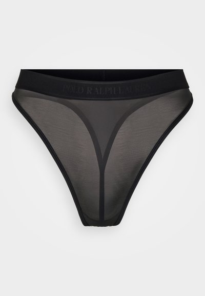 Melna sietveida tanga apakšveļa ar gludu elastīgu jostu un diskretu logo detaļu. Satiekas minimālisma dizains ar caurspīdīgu tekstūru.