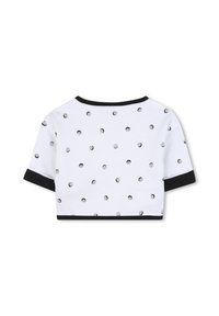 Maglietta corta bianca con un motivo stampato in nero di piccoli volti, rifinita con bordi neri sul collo e sulle maniche. Tessuto morbido.