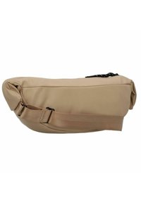 Beige, slouchy shoulder bag with a smooth texture, adjustable strap, and a black zipper detail. Rounded shape, compact design.