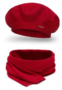 Red knitted beret with a smooth texture and a small metallic logo. Complementing red knitted scarf, featuring a soft, seamless design.