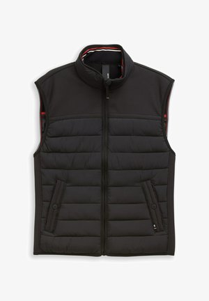 Gilet imbottito nero senza maniche con collo alto, zip frontale e due tasche laterali con bottone, progettato per il calore e l'uso all'aperto.