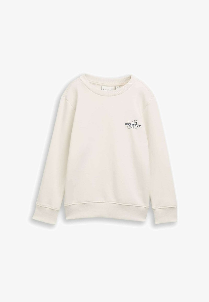 Sweatshirt beige clair à manches longues, col rond et poignets côtelés. Présente un texte graphique "WHAT'S UP" en couleurs contrastées sur le devant.