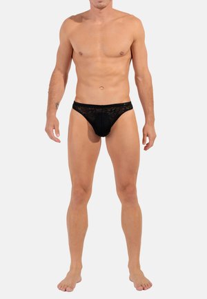 Schwarzer Spitzen-Männertanga mit transparentem Design, elastischem Bund und minimaler Bedeckung, mit floralen Mustern und einer glatten Textur.
