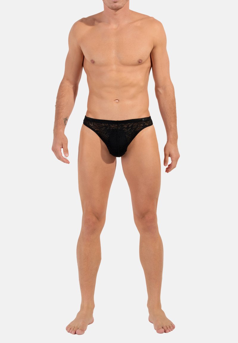 Schwarzer Spitzen-Männertanga mit transparentem Design, elastischem Bund und minimaler Bedeckung, mit floralen Mustern und einer glatten Textur.