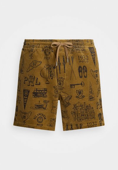 Pruunist korduroost valmistatud lühikesed püksid, millel on mustad trükitud mustrid, sealhulgas logo, spordivarustus ja hooned. Viimistletud paelaga vöös.