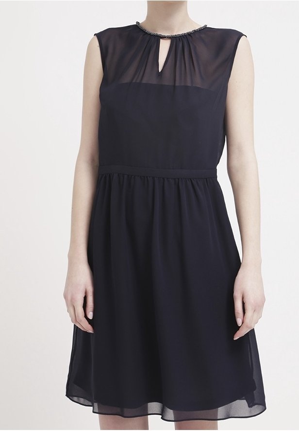 Abito blu navy con tessuto trasparente, scollatura a chiave e dettagli di perline. Vita aderente con gonna svasata che arriva sopra il ginocchio.