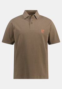 Tummanruskea polo-paita, joka on valmistettu tekstuurikankaasta. Paidassa on kaulus, kaksi nappia ja vasemmassa rinnassa oranssi "JP 1880" -logo.