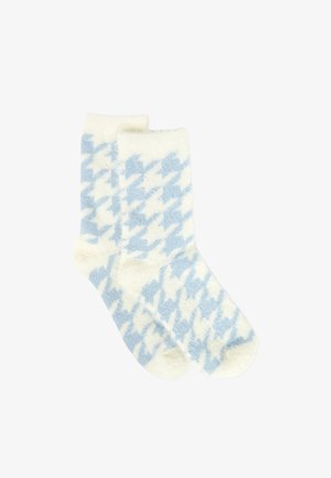 Weiche, flauschige Socken mit einem großen blau-weißen Hahnentrittmuster, nebeneinander auf einem schlichten weißen Hintergrund dargestellt.