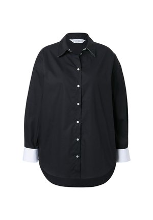 Mustapaita, jossa on pitkät hihat, valkoiset hihaiseta ja valkoiset napit. Paidassa on terävä kaulus ja pyöristetty helma.