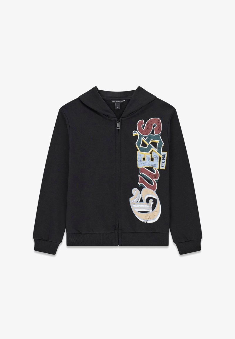 Sweat à capuche zippé noir avec texte coloré style vintage "GUESS EST. 1981" imprimé verticalement sur le côté droit.