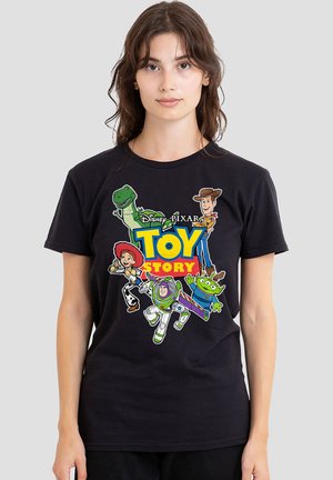 Woman wearing black T-shirt featuring Toy Story characters Buzz Lightyear, Woody, Jessie, Rex, and Alien with colorful logo.