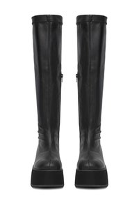 Botas de cuero negro hasta la rodilla con una suela plana, que presentan una textura suave, una silueta alta y cierres de cremallera en los laterales.