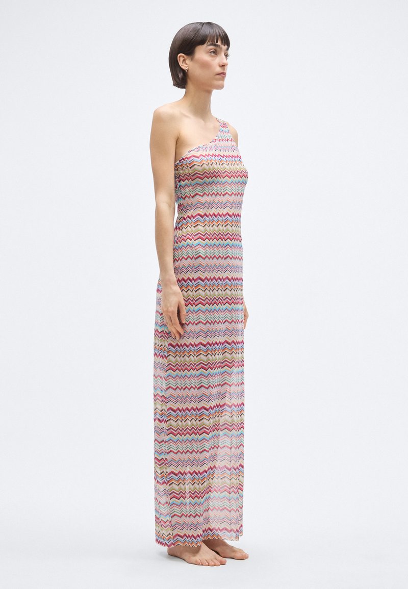 Maxi dress with one shoulder design, featuring a multicolored zigzag pattern. Lightweight, sheer fabric drapes to the ankles.
