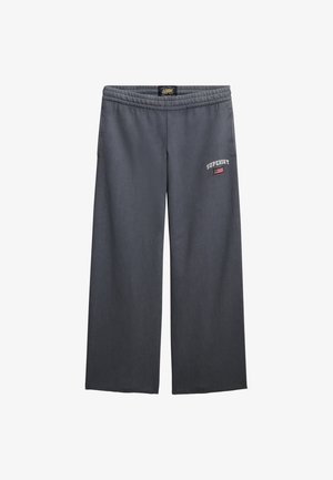 Grijze wijde sweatpants met een elastische tailleband, voorzien van het "Superdry"-logo en een klein detail van de Amerikaanse vlag op de voorkant.