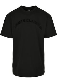 T-shirt en coton noir avec le logo "URBAN CLASSICS" en relief sur la poitrine. Coupe standard, manches courtes, col rond.