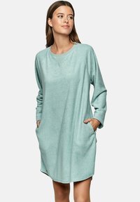 Mintgroene, lange mouwen, pullover jurk gemaakt van een zachte textuurstof, met zijzakken en een relaxte pasvorm.