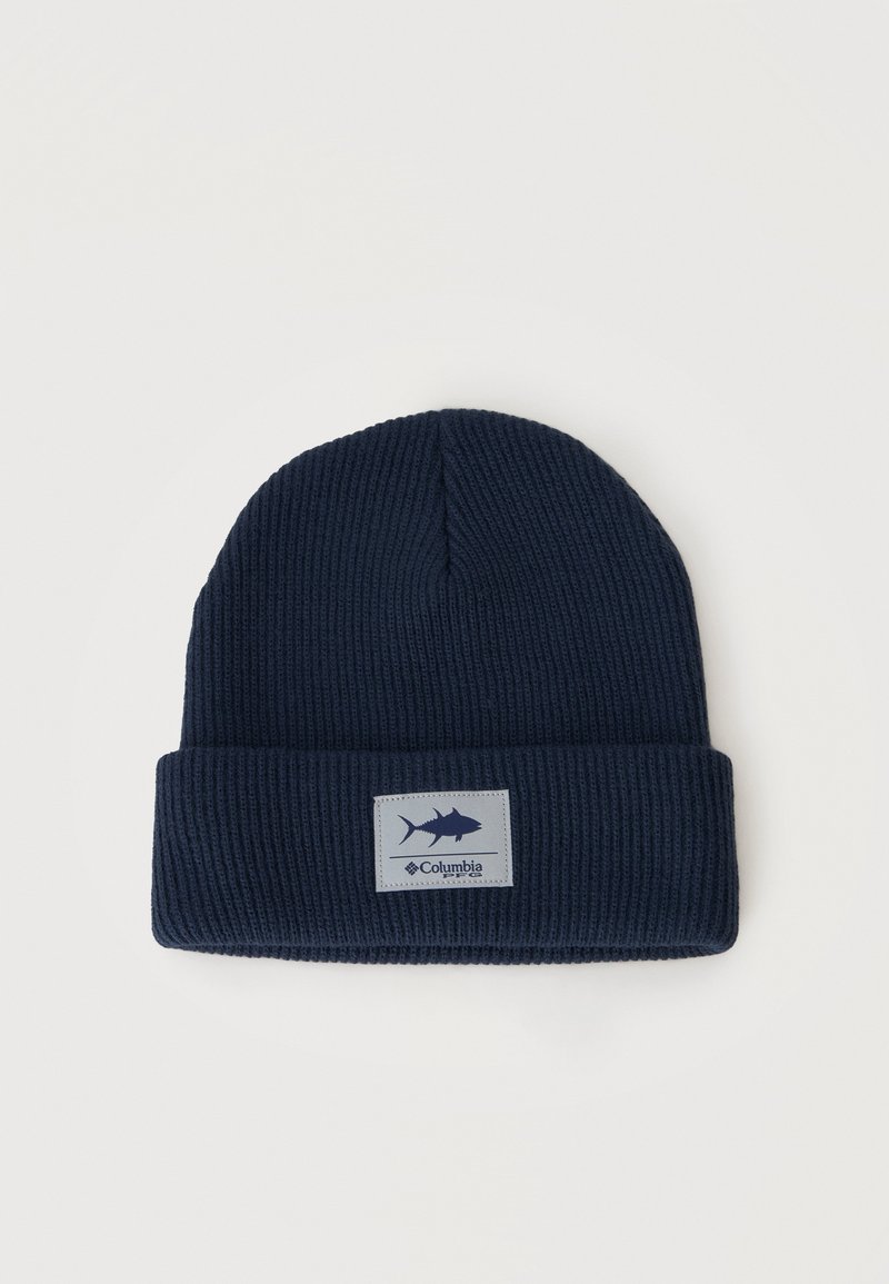 Bonnet en maille côtelée bleu marine avec revers plié et écusson logo Columbia orné d'une icône de poisson à l'avant.