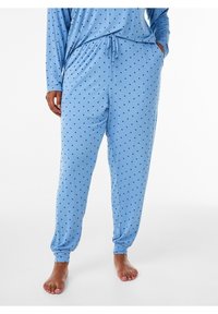 Ljusblå pyjamas med svarta prickar. Långärmad topp och byxor med elastisk midja och sidofickor, med en mjuk och len textur.