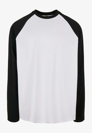 Maglia raglan a maniche lunghe con corpo bianco e maniche nere, realizzata in morbido tessuto di cotone, con scollatura rotonda e vestibilità comoda.