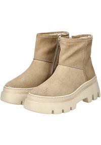 Brune suède ankelstøvler med lynlås, der har en chunky beige gummisål og blødt foer. Overdelen er glat med minimal syning.