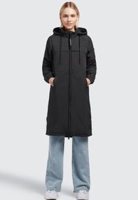 Black long coat with a zip front, adjustable hood, and two side pockets. Made from a smooth material, featuring elastic cuffs and slight sheen.