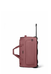 Sac de voyage à roulettes en rose poussiéreux, fabriqué en tissu durable, avec des roues noires, une poignée télescopique et deux sangles de transport sur les côtés.