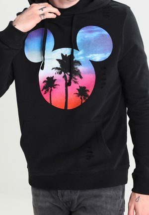Sweat à capuche noir avec une grande silhouette de tête de Mickey Mouse remplie d'un coucher de soleil coloré et d'un motif de palmier sur le devant.