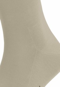 Calzini alla caviglia di colore beige realizzati in un materiale testurizzato e elastico. Presentano un design a coste e una punta senza cuciture per il massimo comfort.