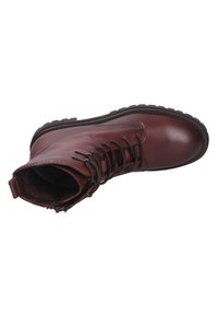 Brown leather ankle boot with laces, round toe, and rugged sole. Features a zipper on the side and subtle stitching accents.