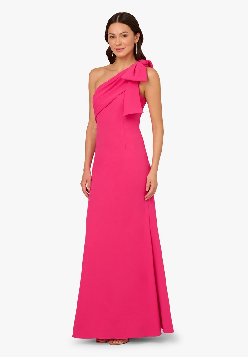One-shoulder pink gown with a bow accent, fitted silhouette, floor-length design, smooth fabric texture, and minimal detailing.