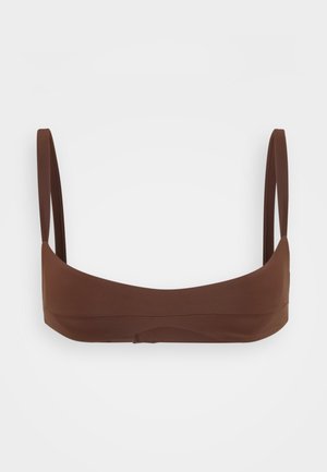 Brown bikini top made of smooth fabric with thin straps and a seamless design, featuring a minimalistic, contoured shape.