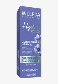 Opakowanie olejku do włosów Weleda Hydra Shine Gloss Drops w prostokątnej fioletowej pudełku z białym i srebrnym tekstem, botanicznymi ilustracjami oraz naturalnymi olejami.