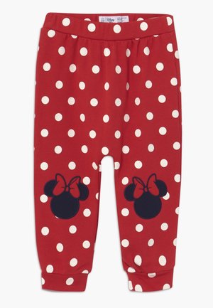 Rote Kleinkinderhose mit weißen Punkten und schwarzen Minnie-Maus-Kopf-Motiven mit roten Schleifen auf den Knien.